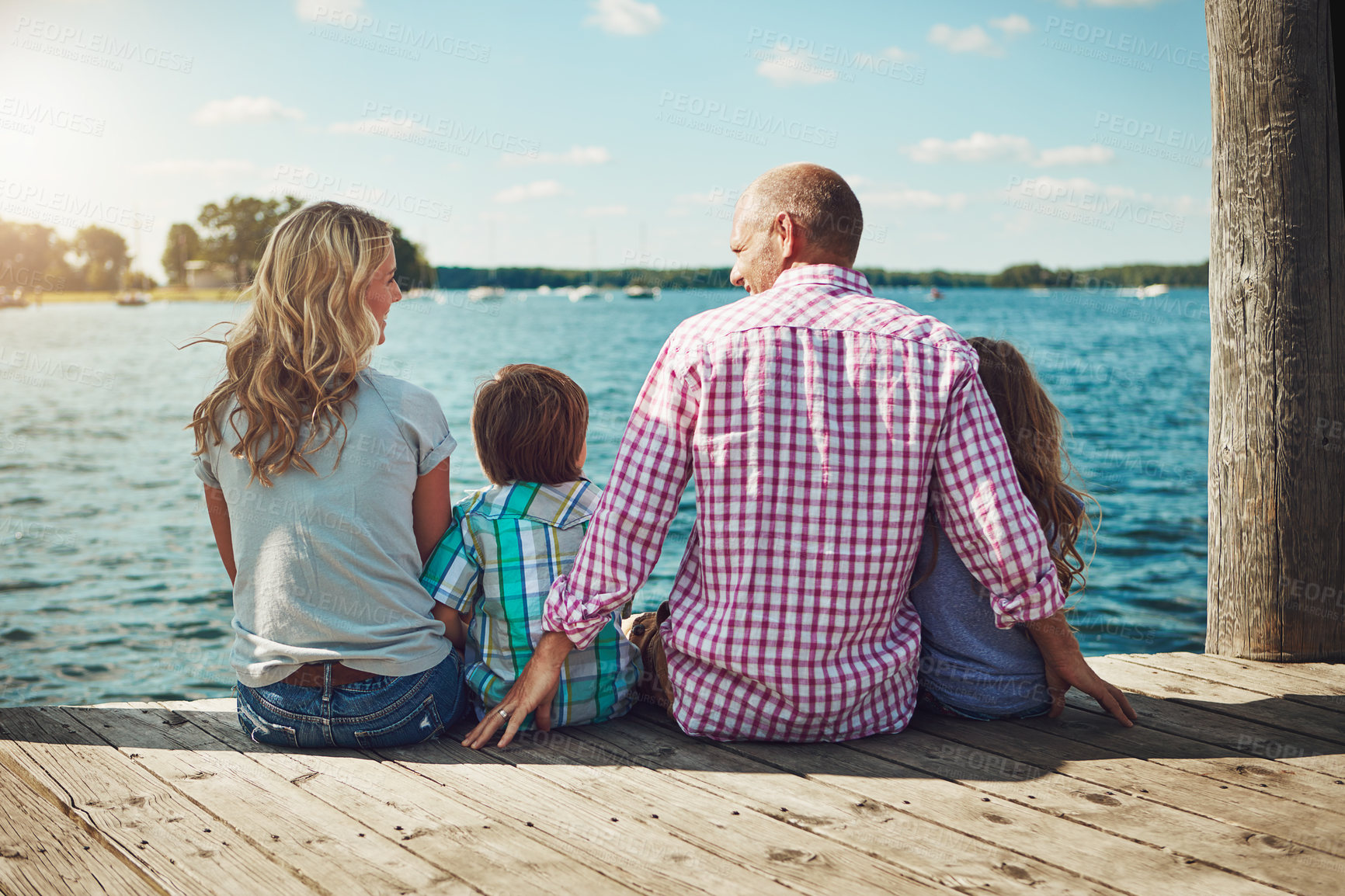 Buy stock photo Family, lake and relax on vacation for bonding, peace and travel for fun by water together. Parents, children and love on holiday by river or care in nature, back and outdoor for relationship on trip