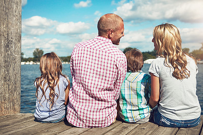 Buy stock photo Family, lake and pier on vacation for talking, peace and travel to relax by water together. Parents, children and love on holiday by river or care in nature, back and outdoor for relationship on dock