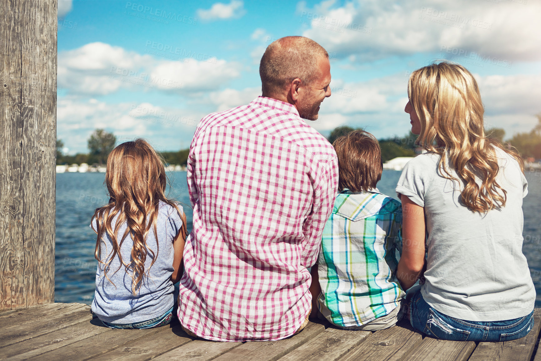 Buy stock photo Family, lake and pier on vacation for talking, peace and travel to relax by water together. Parents, children and love on holiday by river or care in nature, back and outdoor for relationship on dock