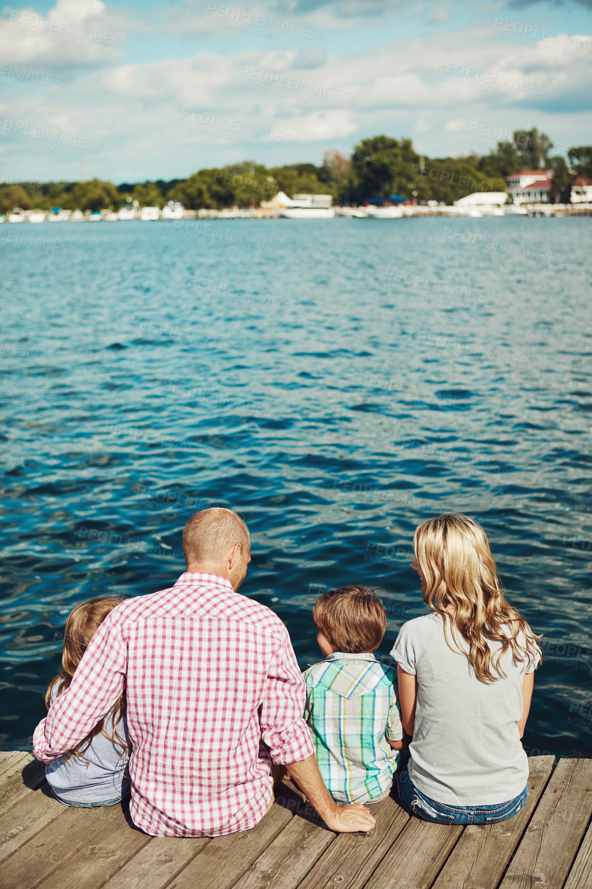 Buy stock photo Family, lake and jetty on vacation for bonding, peace and travel to relax by water together. Parents, kids and love on holiday by river or care in nature, back and outdoor for relationship on dock