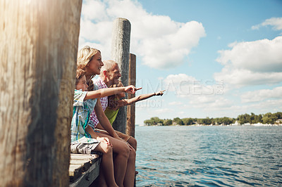 Buy stock photo Shot of a young family on a pier while out by the lake