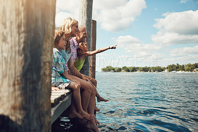 Buy stock photo Shot of a young family on a pier while out by the lake