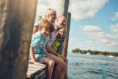 Buy stock photo Shot of a young family on a pier while out by the lake