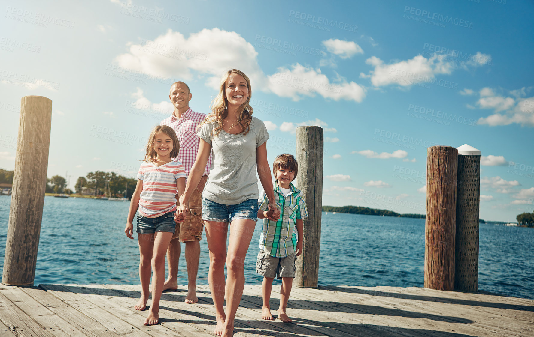 Buy stock photo Holiday, pier and family with kids, holding hands and bonding together with weekend break. Lake, happy parents and mother with father, children and low angle with vacation, view and journey in Italy
