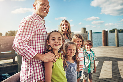 Buy stock photo Shot of a young family on a pier while out by the lake