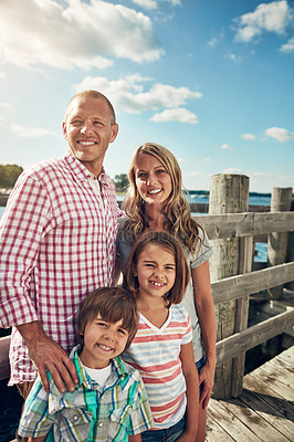 Buy stock photo Shot of a young family on a pier while out by the lake