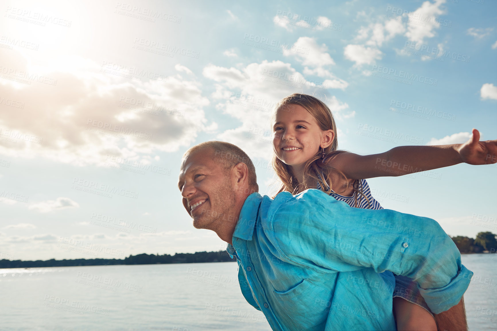 Buy stock photo Shot of a middle-aged man and his young daughter spending some quality time at the beach