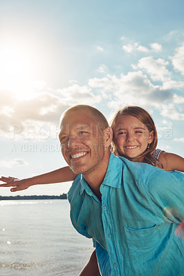 Buy stock photo Shot of a middle-aged man and his young daughter spending some quality time at the beach