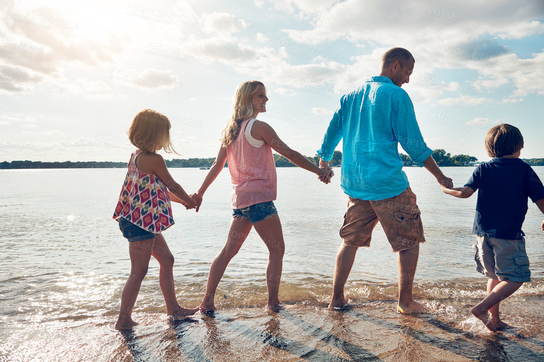 Buy stock photo Family, back and walking in beach or holding hands and travel for summer, holiday and nature in California. Parents, kids and adventure in tropical sea and man with woman, together and children
