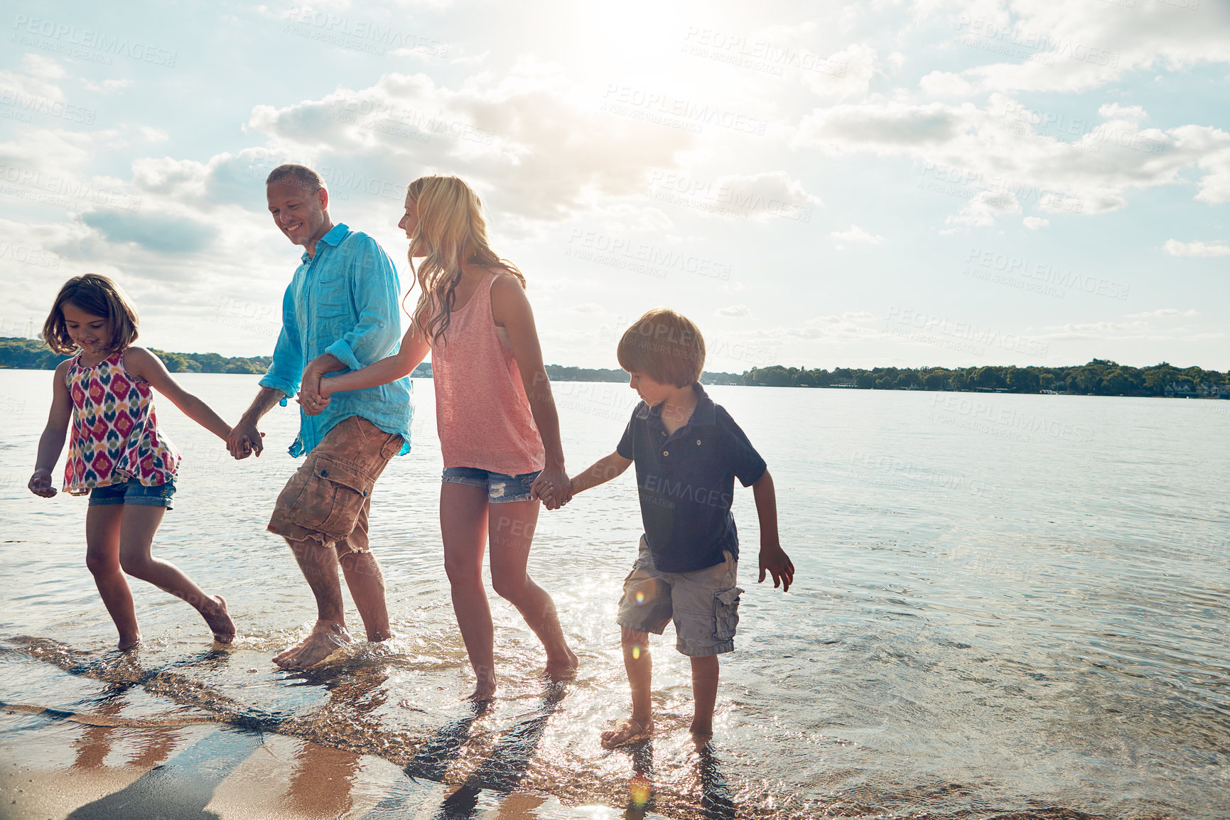 Buy stock photo Family, playful and walking in beach or holding hands and travel for summer, holiday and nature  of California. Parents, kids and adventure in tropical sea and man with woman, water and children