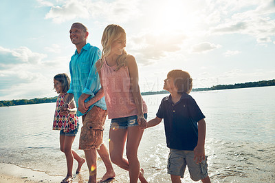 Buy stock photo Shot of a beautiful family spending some quality time on the beach