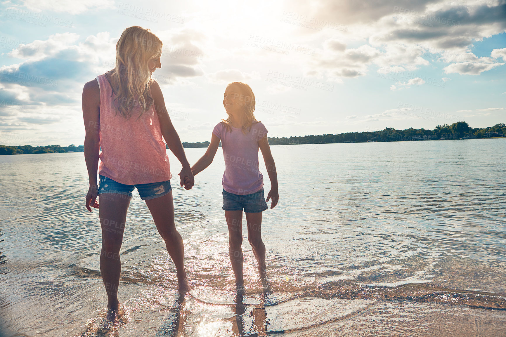 Buy stock photo Sky, mother and child on beach holding hands with smile, walking and fun adventure holiday in Australia. Travel, mom and girl on ocean vacation with summer, happy support and outdoor bonding together