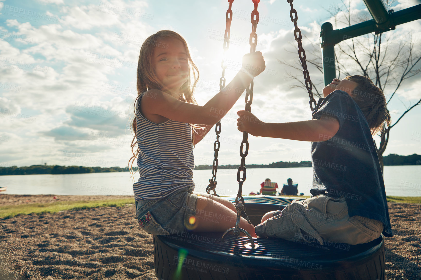 Buy stock photo Children, tire swing and portrait in nature, bonding and friends at playground for game or adventure. Kids, lens flare and together for fun in backyard or freedom, siblings and connection on vacation