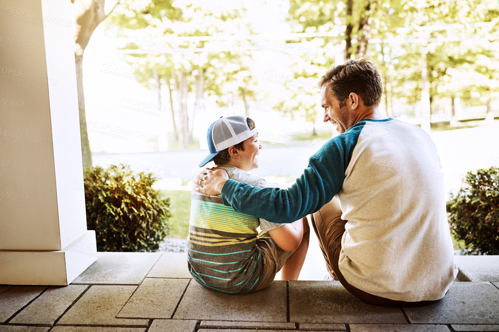 Buy stock photo Porch, hug and father with son, sunshine and happiness with weekend break, bonding together and relax. Single parent, outdoor and papa with boy, family and cheerful with conversation, home and summer