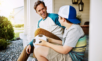 Buy stock photo Shot of a father and his son bonding on their porch at home