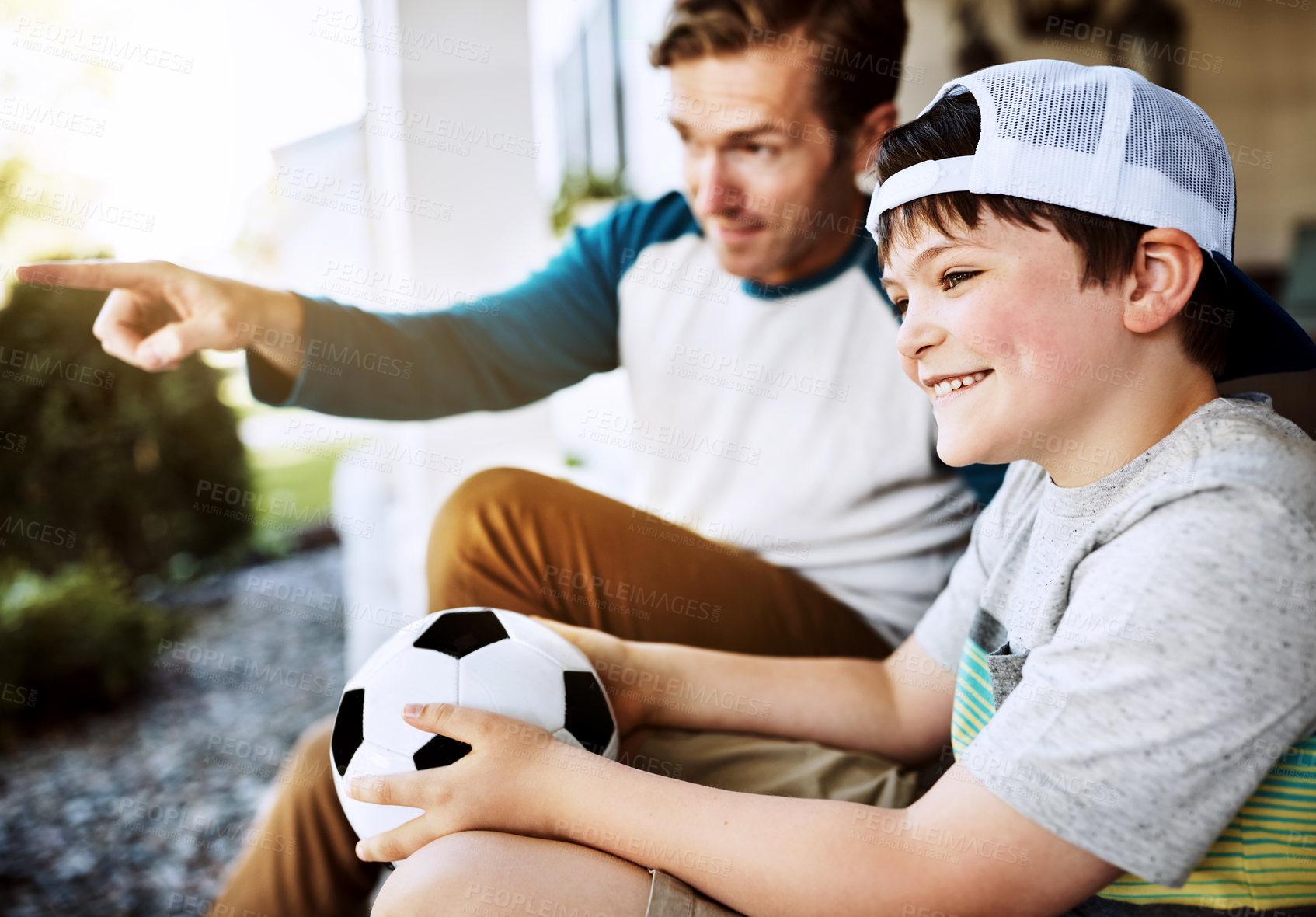 Buy stock photo Shot of a father and his son bonding on their porch at home