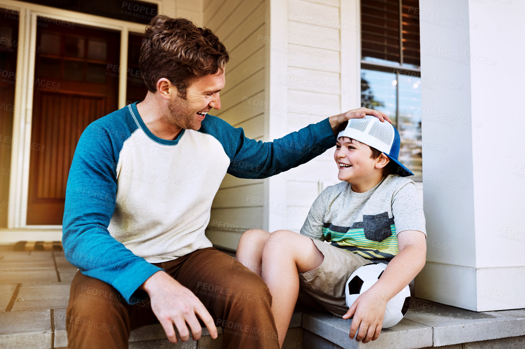 Buy stock photo Love, laugh or father and son with soccer ball on porch for funny conversation, advice or bonding. Happy family, chat or man with kid outdoor for football help, talking or learning, teaching and care