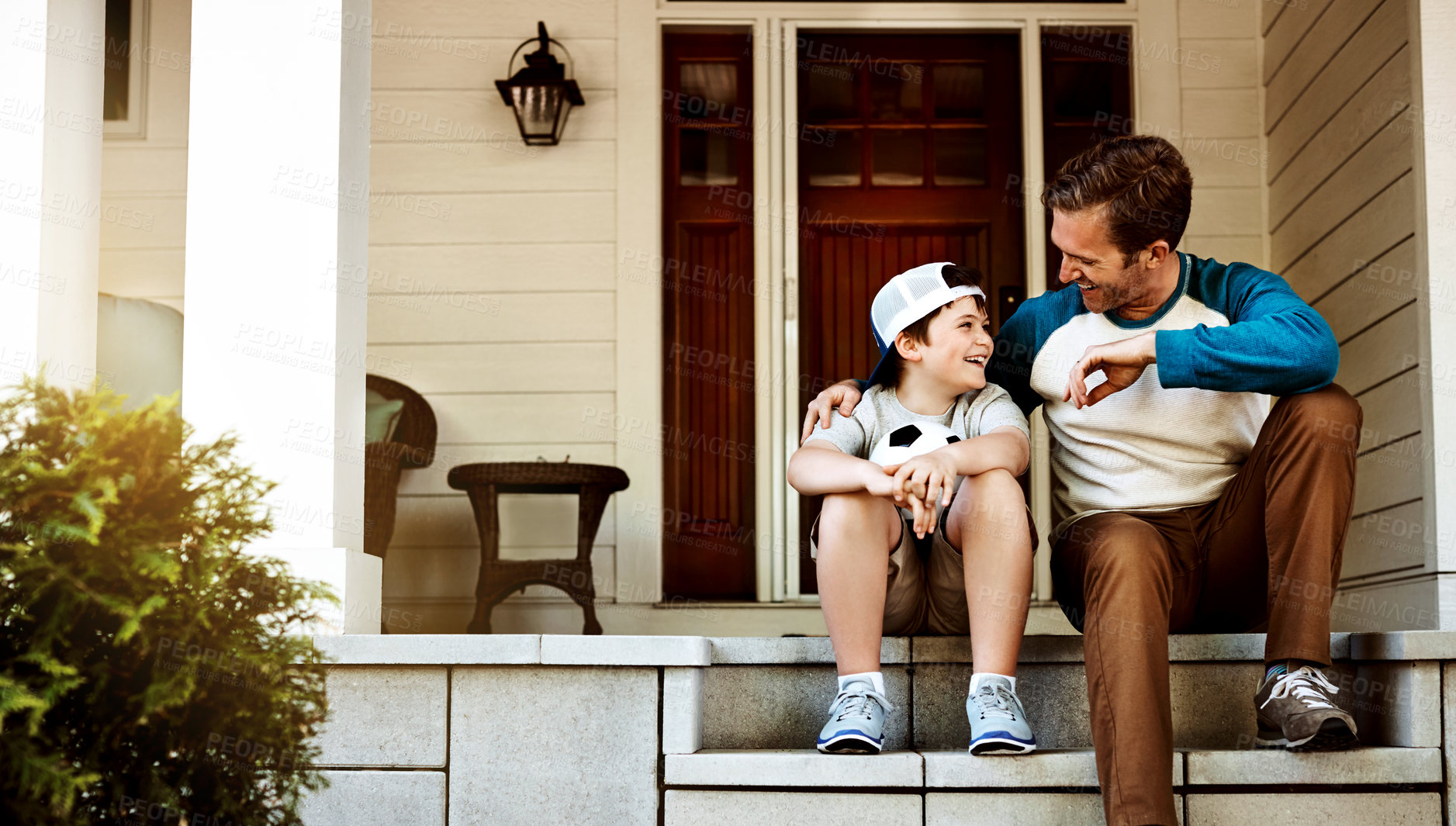 Buy stock photo Shot of a father and his son bonding on their porch at home