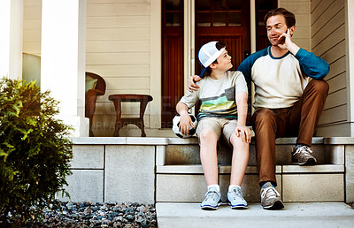 Buy stock photo Shot of a father and his son bonding on their porch at home