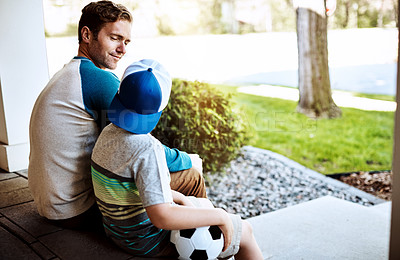 Buy stock photo Rearview shot of a father and his son bonding on their porch at home