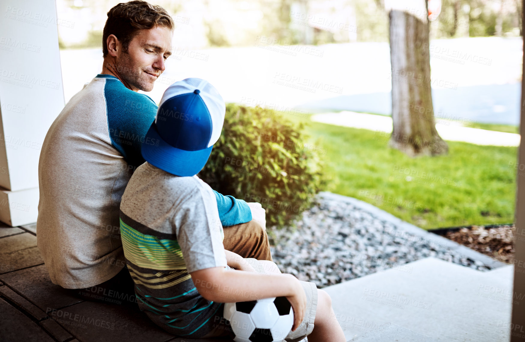 Buy stock photo Love, bonding and father and son relax on porch with soccer ball for learning, teaching and game advice. Family, support and papa with kid in a backyard for football tips, conversation or security