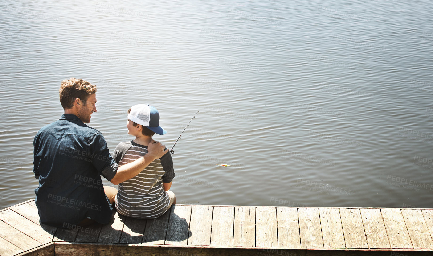 Buy stock photo Fishing, lake and father with child by water for teaching skill, adventure and vacation together outdoors. Family, happy and dad with young boy by river with rod for sports, hobby and catch fish