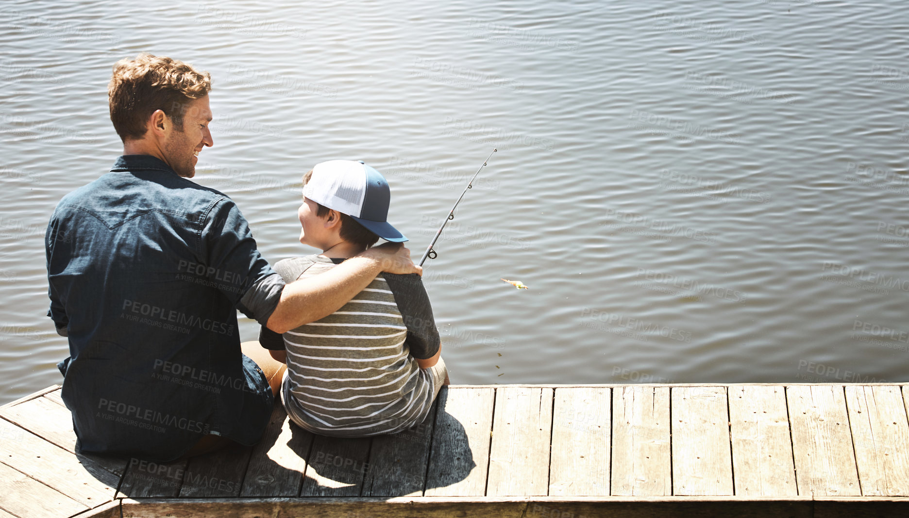 Buy stock photo Fishing, happy and father with child by lake for teaching skill, adventure and vacation together outdoors. Family, nature and dad with young boy by river with rod for sports, hobby and catch fish