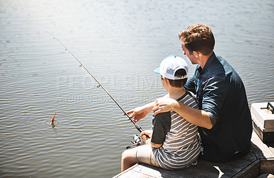 Buy stock photo Father, back and teaching with son for fishing with rod by lake, ocean or beach together in nature. Dad with child, young kid or little boy with hug for bonding lesson or tips to catch by water