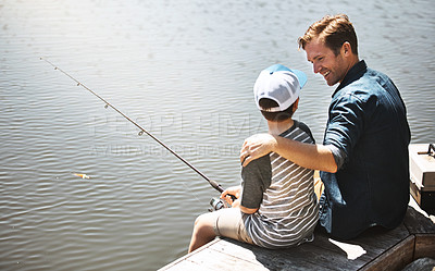 Buy stock photo Rear view shot of a father and his little son fishing together