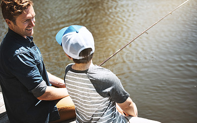 Buy stock photo Rear view shot of a father and his little son fishing together