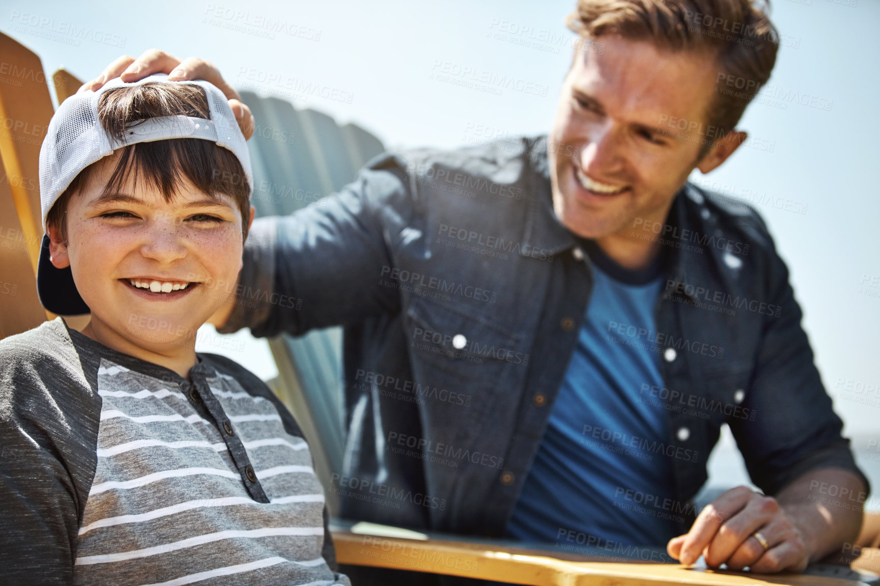 Buy stock photo Portrait of a little boy bonding with his father outdoors