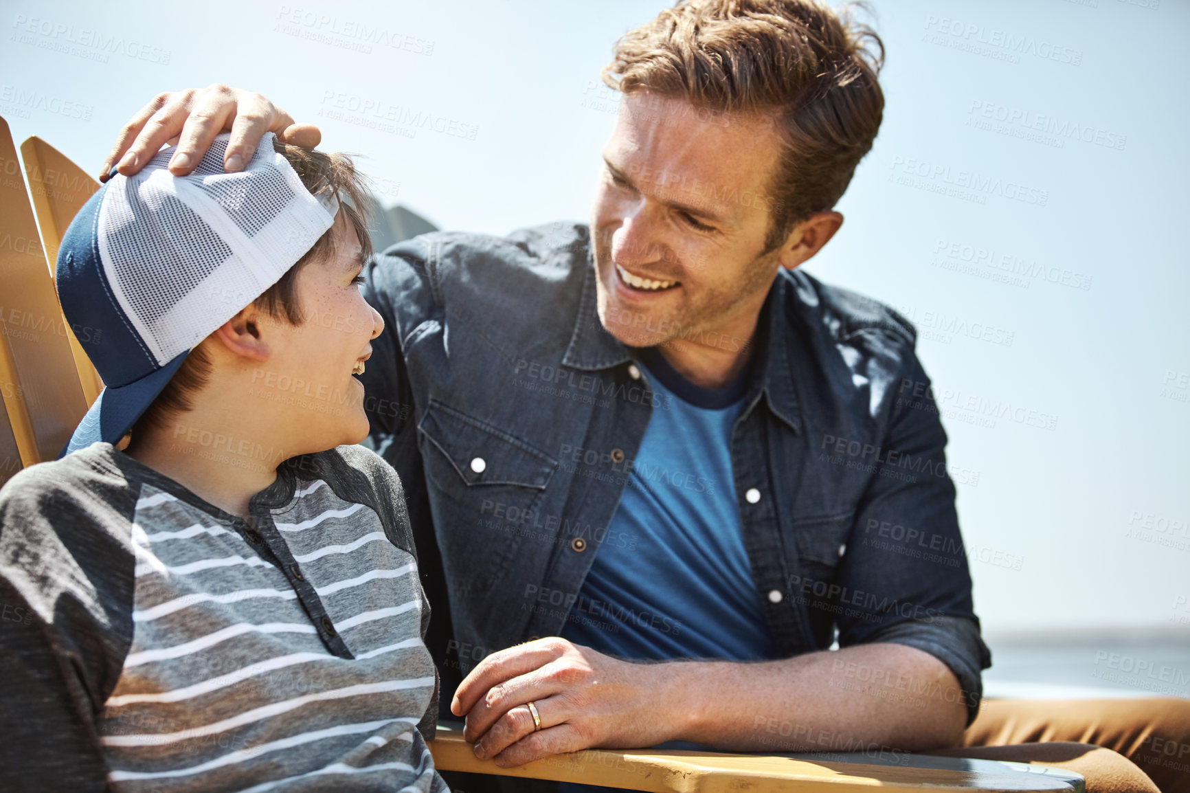 Buy stock photo Shot of a father bonding with his little son outdoors