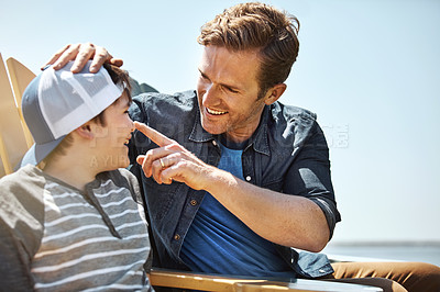 Buy stock photo Shot of a father bonding with his little son outdoors