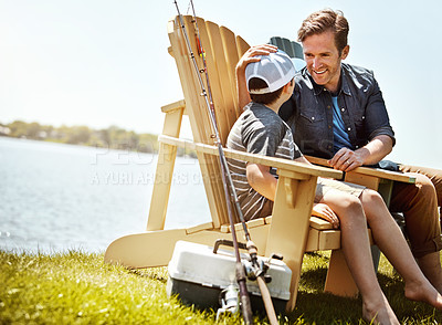 Buy stock photo Shot of a father and his little son enjoying a fishing trip together