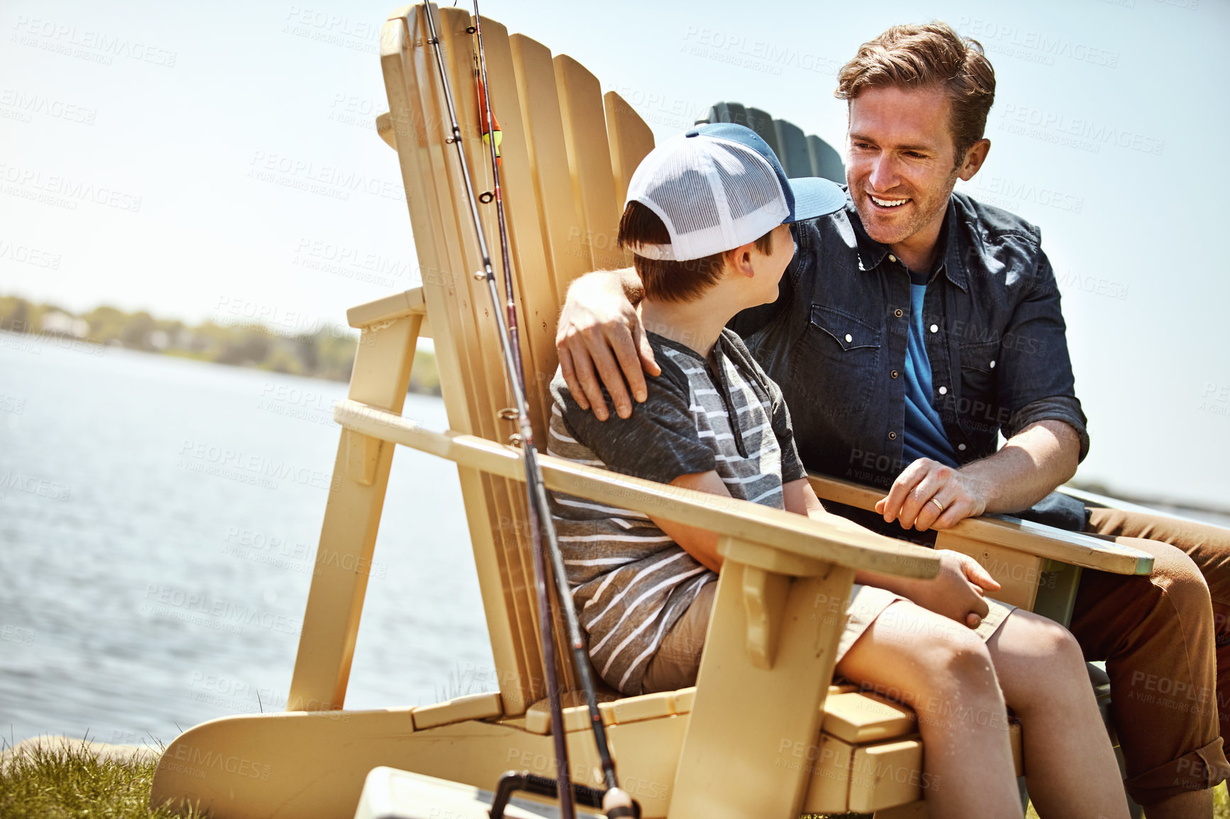 Buy stock photo Shot of a father and his little son enjoying a fishing trip together