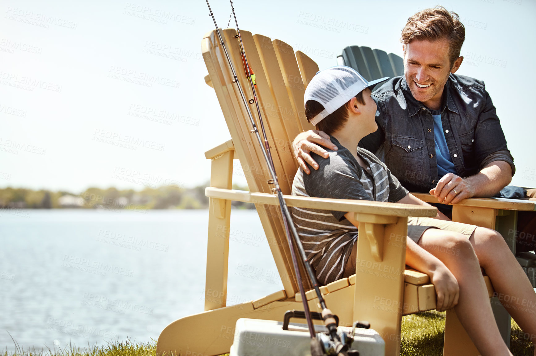 Buy stock photo Shot of a father and his little son enjoying a fishing trip together