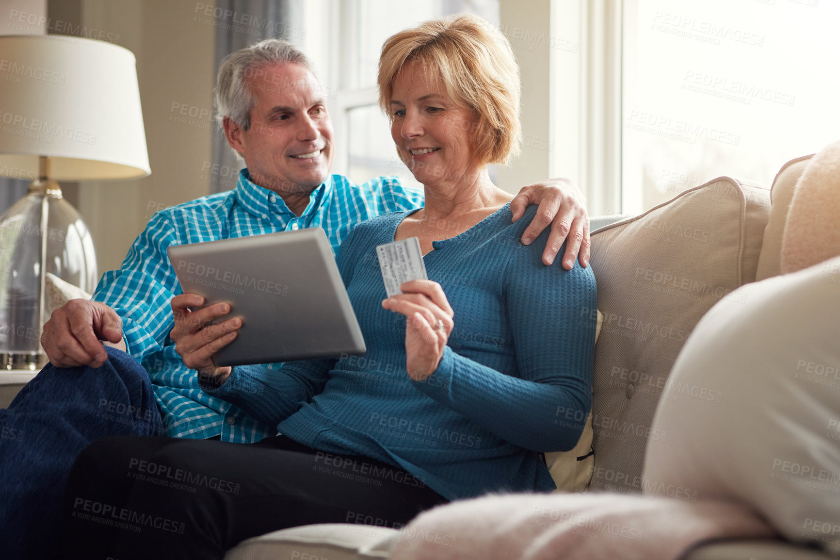 Buy stock photo Senior couple, tablet and credit card on sofa for e commerce, decision and sale on web in home living room. Old man, woman and fintech app for banking with deal, discount and smile on couch in house