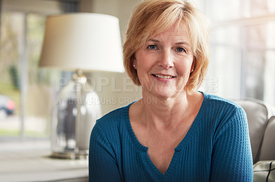 Buy stock photo Portrait of a happy mature woman relaxing on the sofa at home