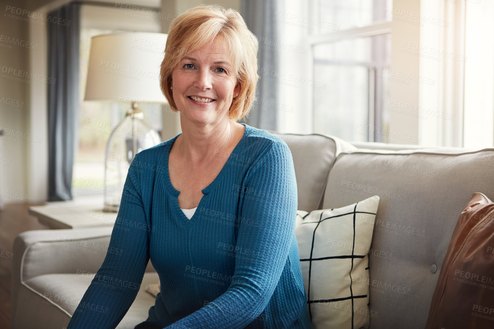 Buy stock photo Portrait of a happy mature woman relaxing on the sofa at home