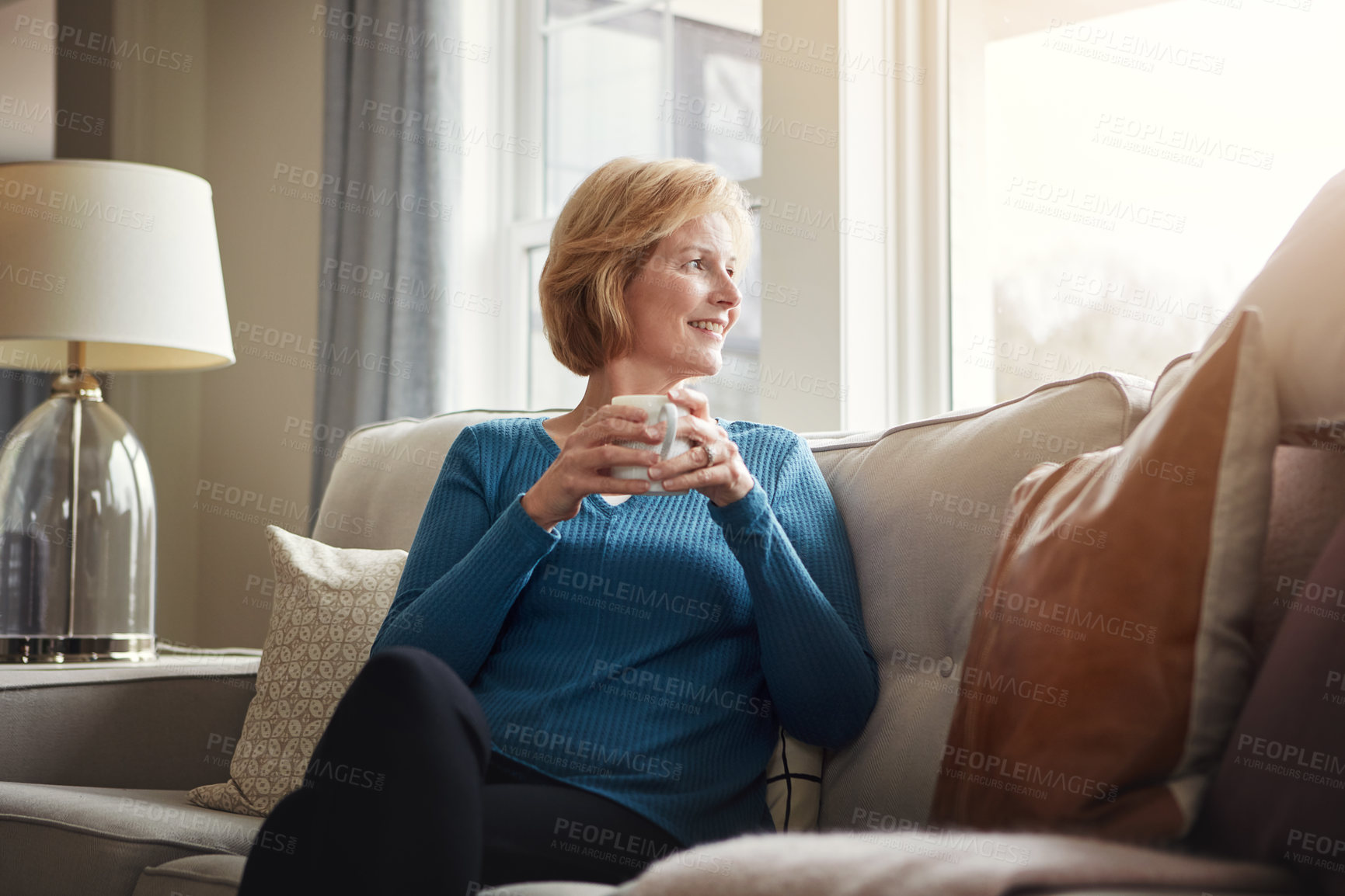 Buy stock photo Memory, thinking and senior woman with coffee on a sofa for peace, reflection and nostalgia with window view. Remember, home and elderly female person with tea in living room with morning resting