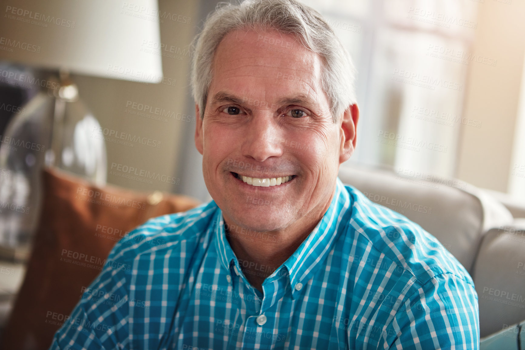 Buy stock photo Portrait of a happy mature man relaxing on the sofa at home