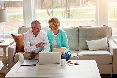 Buy stock photo Senior couple, documents and laptop on couch with discussion, smile and point for taxes in home. Old man, woman and computer with paperwork for compliance, reading and investment report with solution