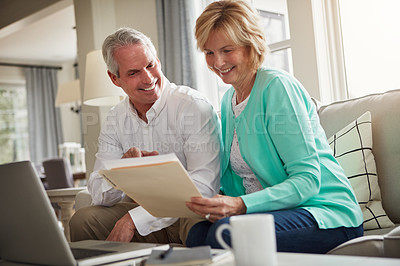 Buy stock photo Senior couple, paperwork and laptop on sofa with discussion, smile and taxes in home. Old man, woman and computer with documents for compliance, reading and investment report with finance management