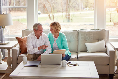 Buy stock photo Senior couple, paperwork and laptop on couch with discussion, smile and point for taxes in home. Old man, woman and computer with documents for compliance, reading and investment report with finance