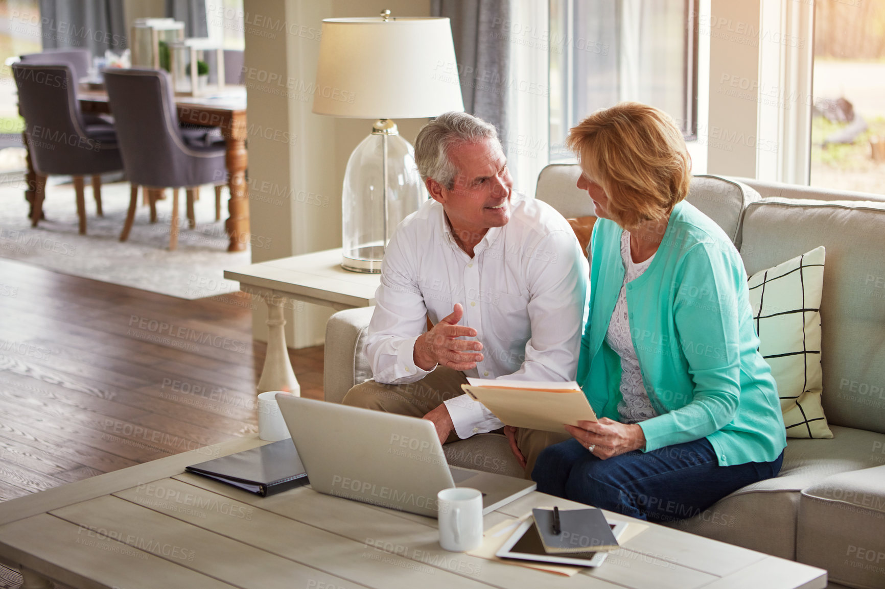 Buy stock photo Senior couple, paperwork and finance on couch with laptop, smile or check for taxes in home. Old man, woman and computer with documents for compliance, audit or investment report for budget review