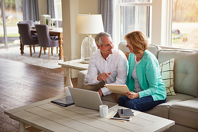 Buy stock photo Senior couple, paperwork and finance on sofa with laptop, smile and talk for profit in home. Old man, woman and computer with documents for compliance, audit and investment report for budget review