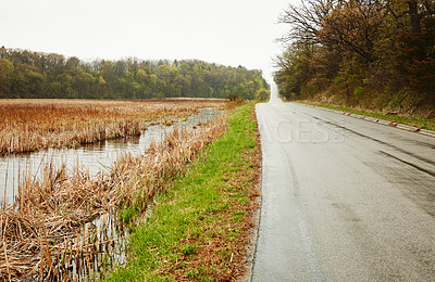 Buy stock photo Shot of an empty road along the countryside