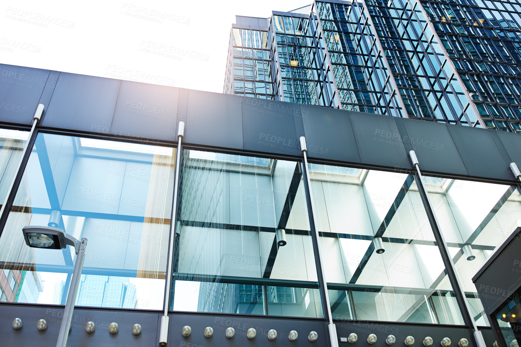 Buy stock photo Low angle shot of a glass corridor in a corporate office building