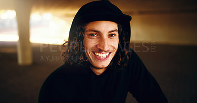 Buy stock photo Cropped portrait of a young man chilling outside in an underground parking lot