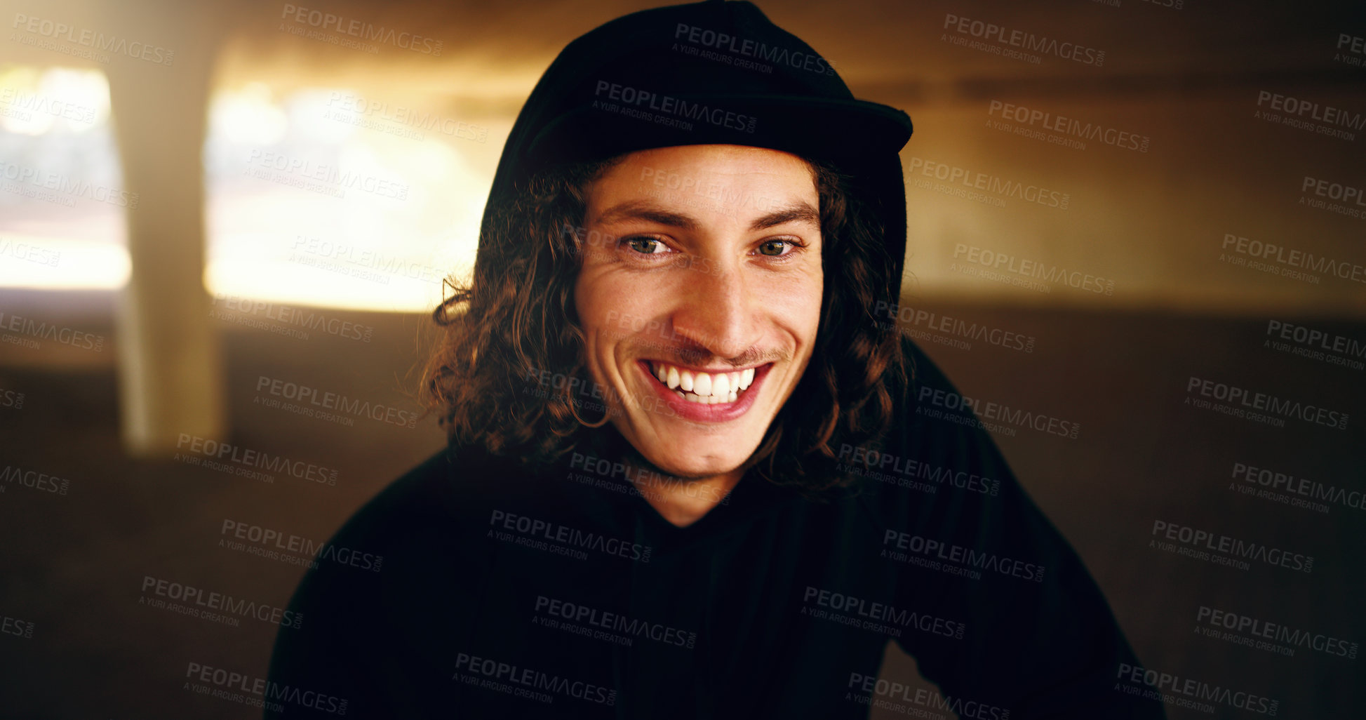 Buy stock photo Cropped portrait of a young man chilling outside in an underground parking lot